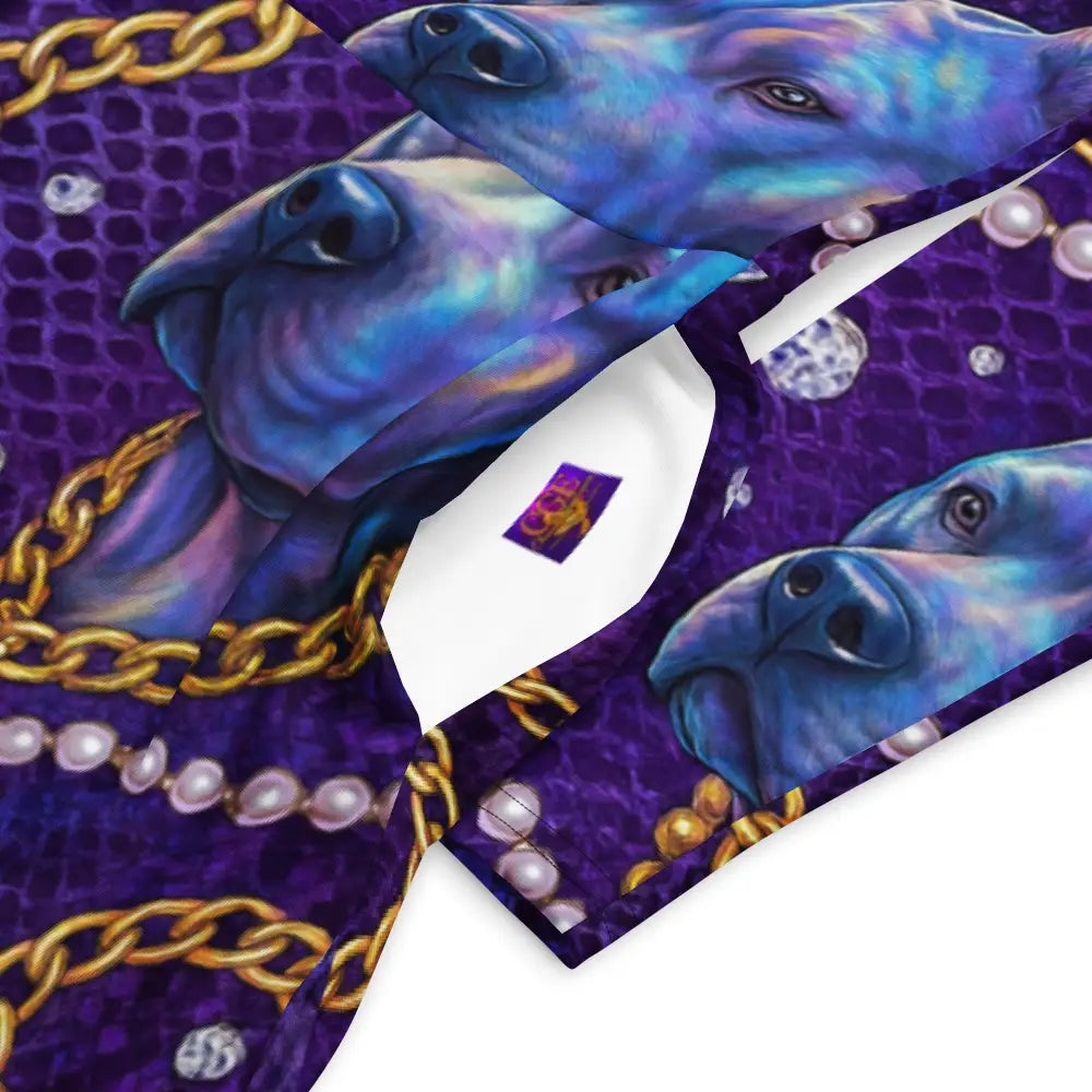 Close-up of royal purple glam midi dress fabric with royal blue dog faces, gold chains, and pearl patterns