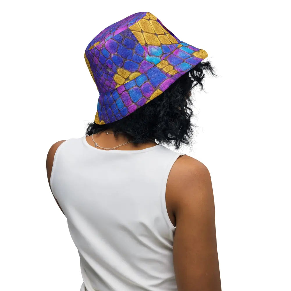 Colorful Bossbabe Bucket Hat with violet-gold snake print and holographic design worn by a woman in white sleeveless top