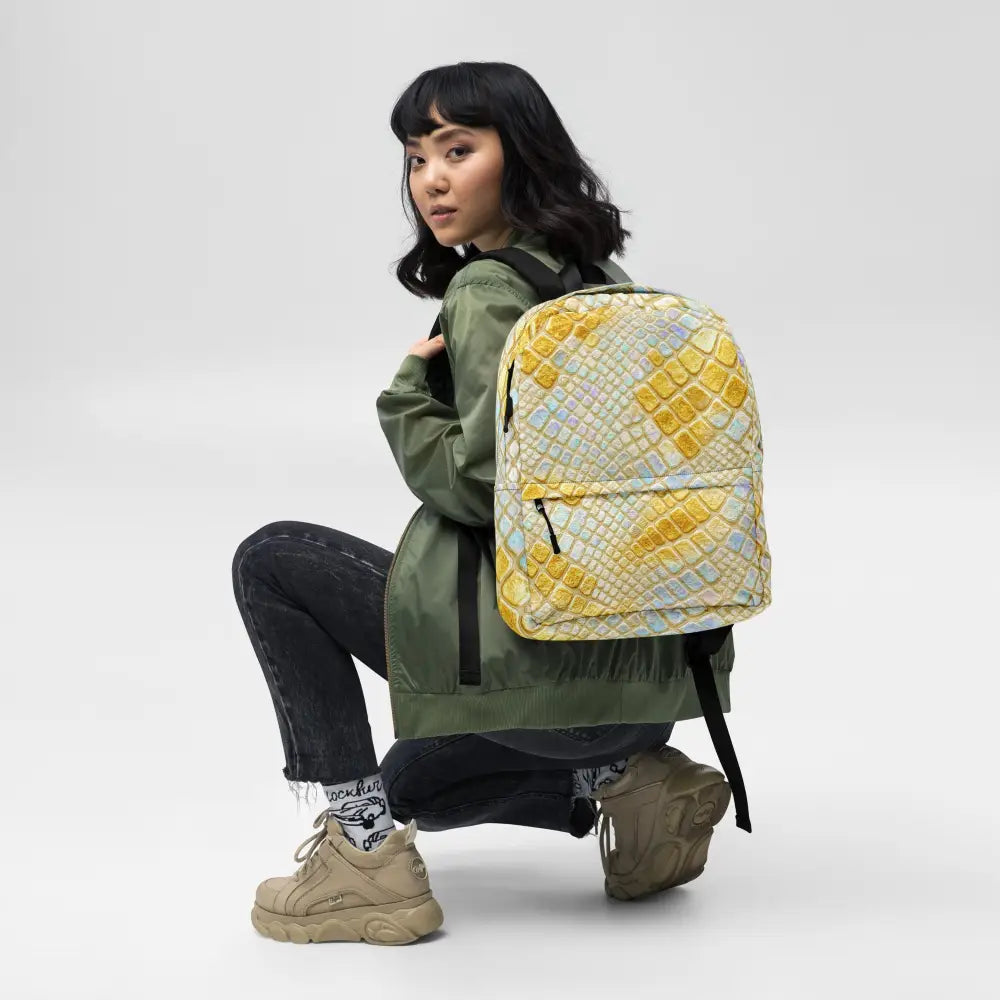 Woman wearing Holo Luxe Snake Backpack with yellow holographic snake pattern, stylish and functional design