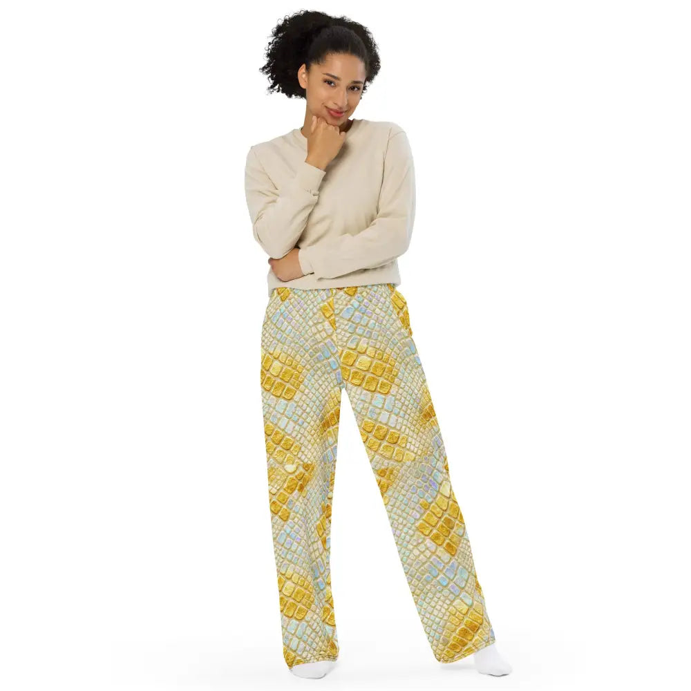 Woman wearing wide leg glam snake cargo pants with gold and pastel allover snake print and beige sweater